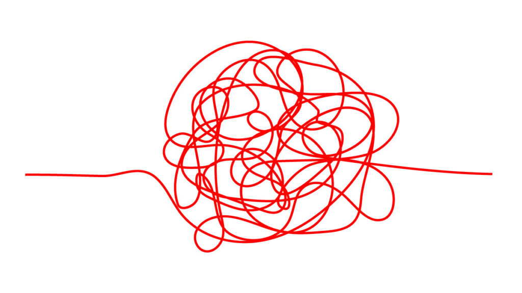 A red string looped over itself repeatedly resulting in an unruly tangle